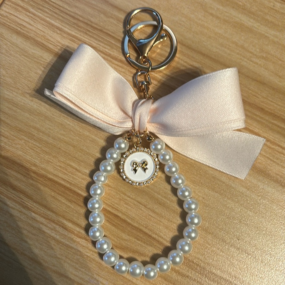 NEW: Cream Bow Bag Charm with Pearl Wristlet